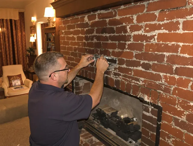 North Olmsted Chimney Sweep expert fixing a fireplace in North Olmsted, OH
